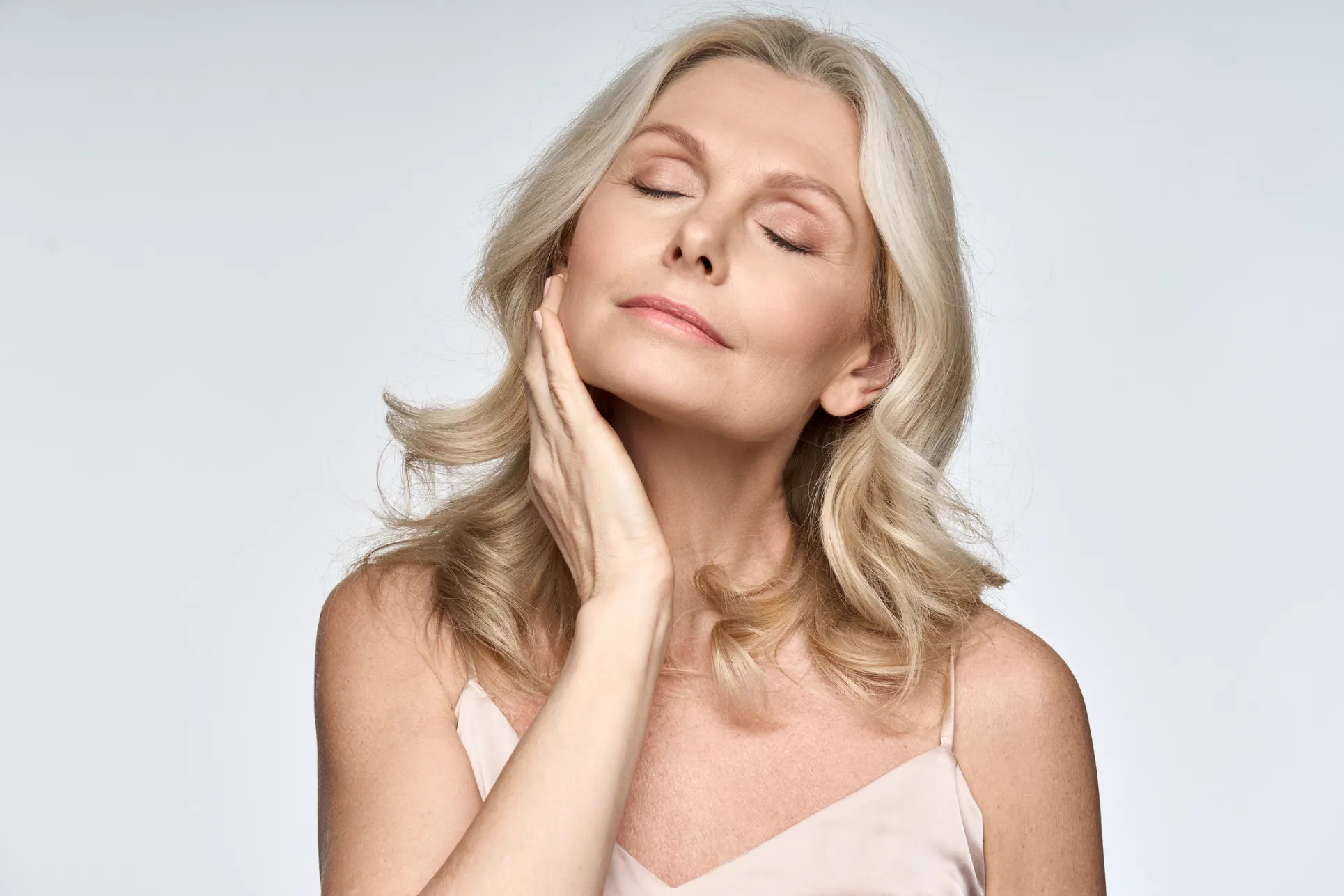 Woman enjoying a relaxing skincare moment with closed eyes